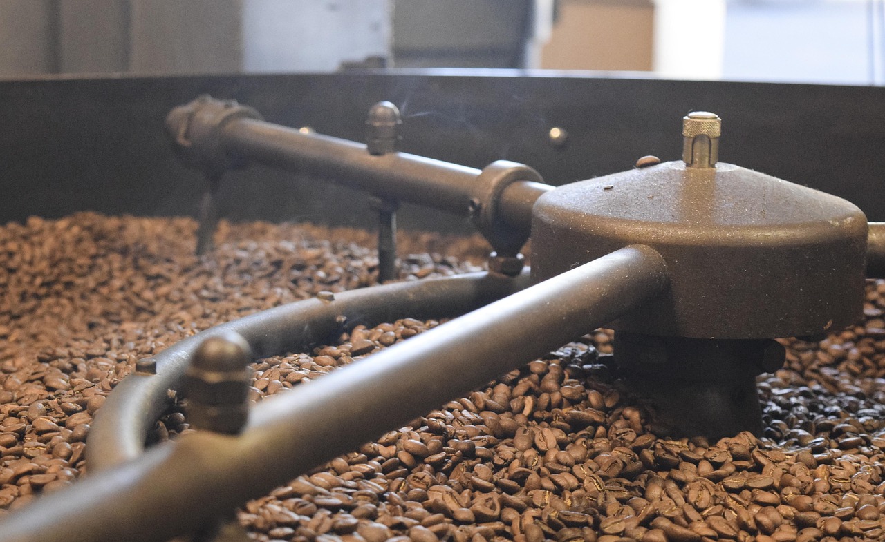 Freshly roasted beans turning in the cooling tray of a drum roaster