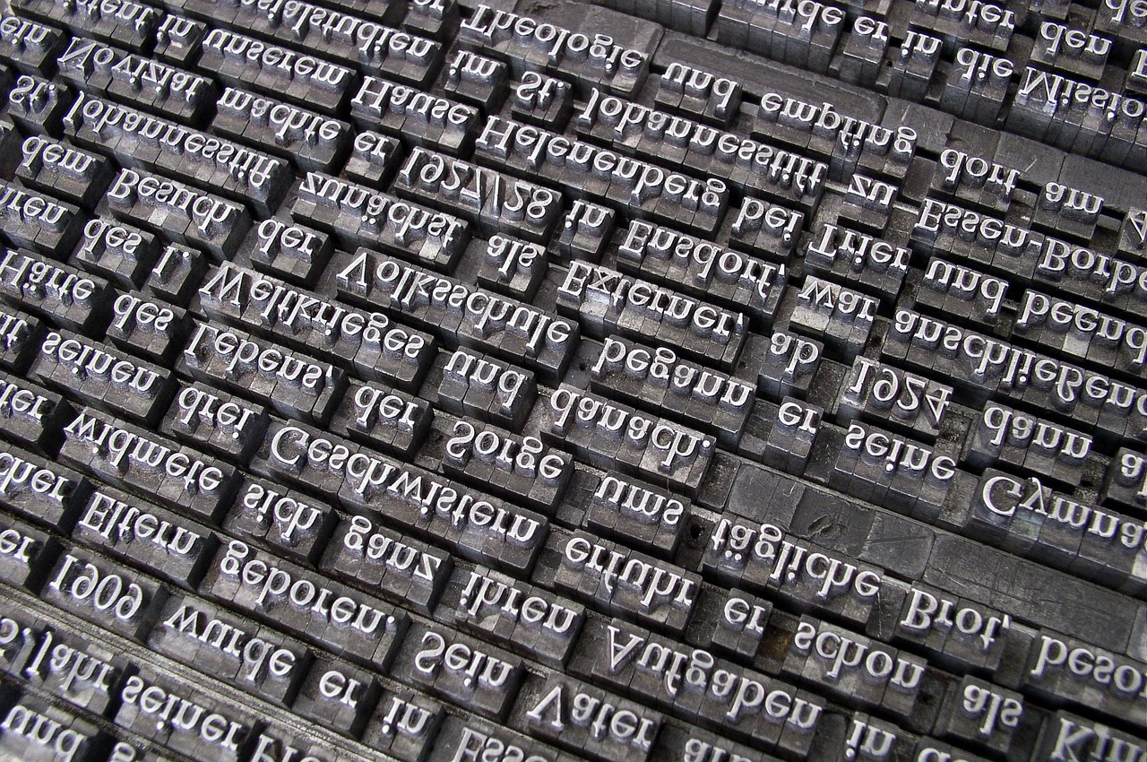 Rows of metal letterpress type locked in a composing frame